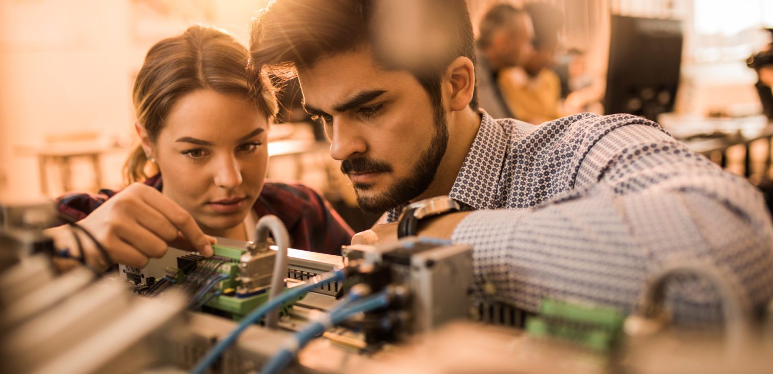 Two-engineering-students-working-on-electrical-component-of-a-machine-in-laboratory-1024x576