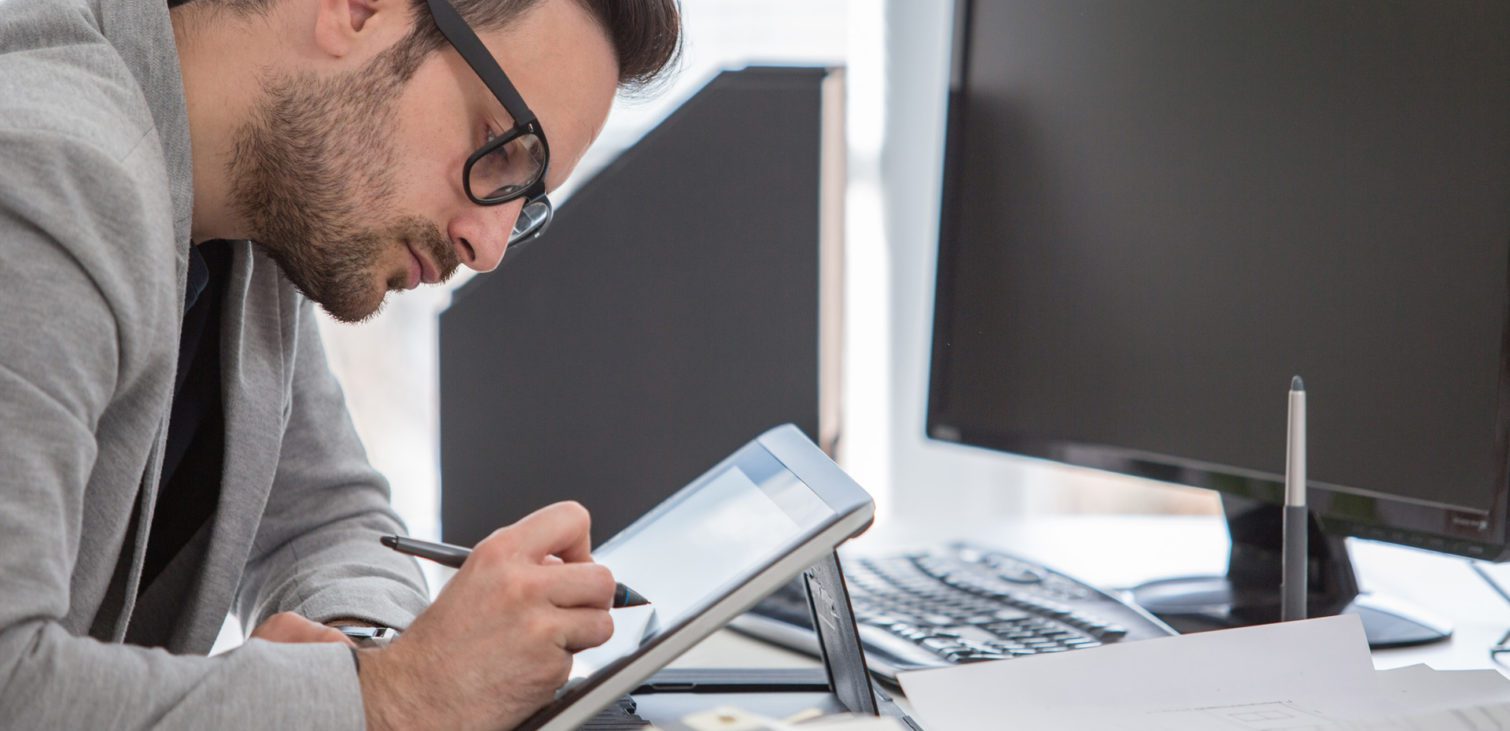 man-sat-at-tablet-with-pen-1024x683