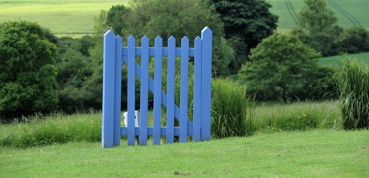 A whimsical blue wooden gate, representing import DXF data design gateway