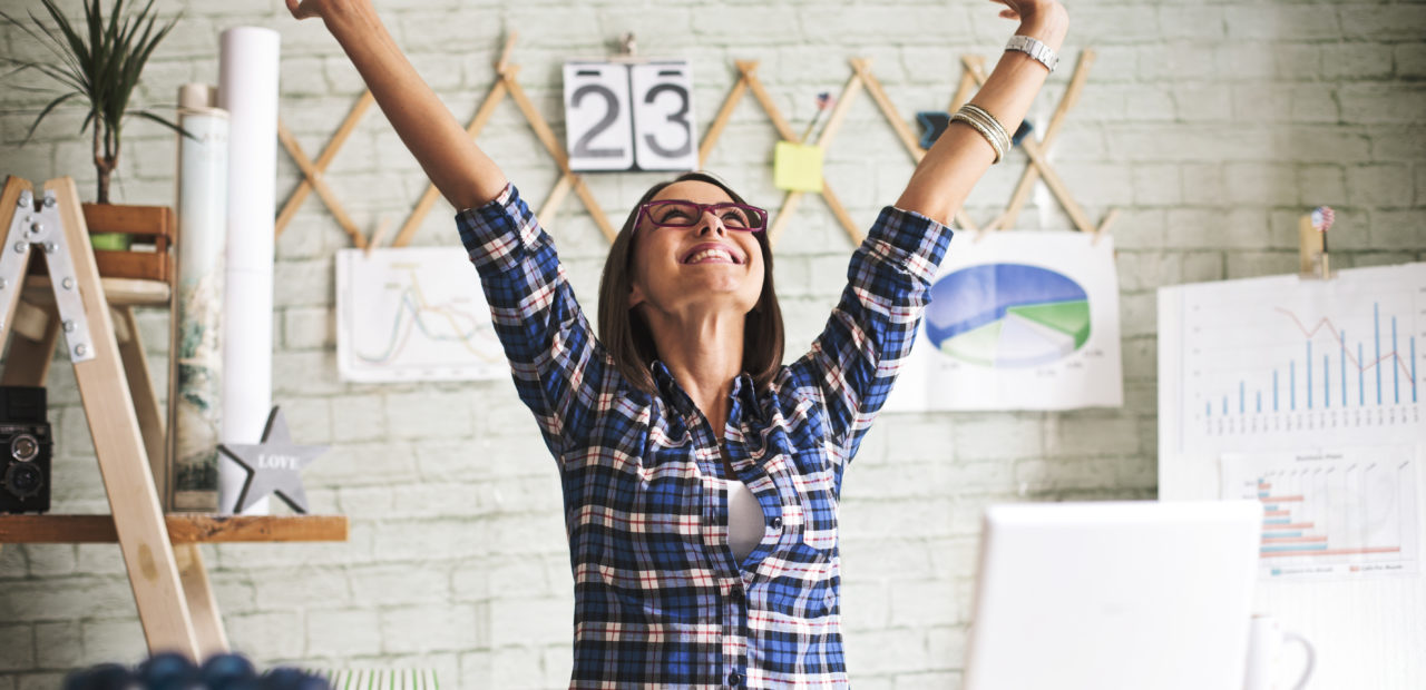 Woman smiling in office, E3.series is an enterprise-grade engineering platform with many collaborative capabilities and solutions.