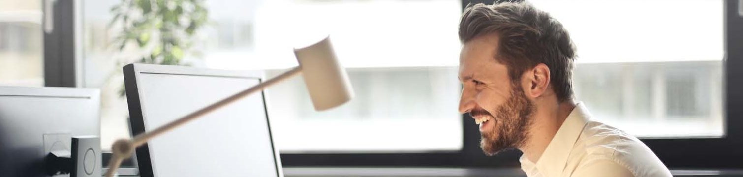 laptop-man-happy-working-pexels-e1552409880758-1024x228