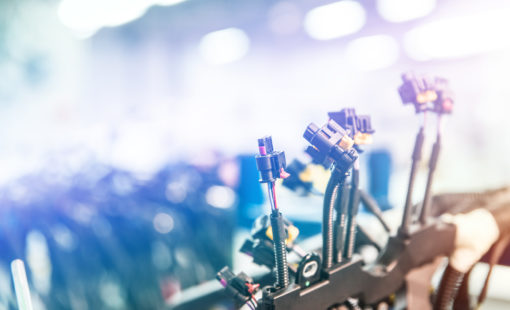 Bunch of wiring harnesses. Automobile industry background with copy space, light effect.