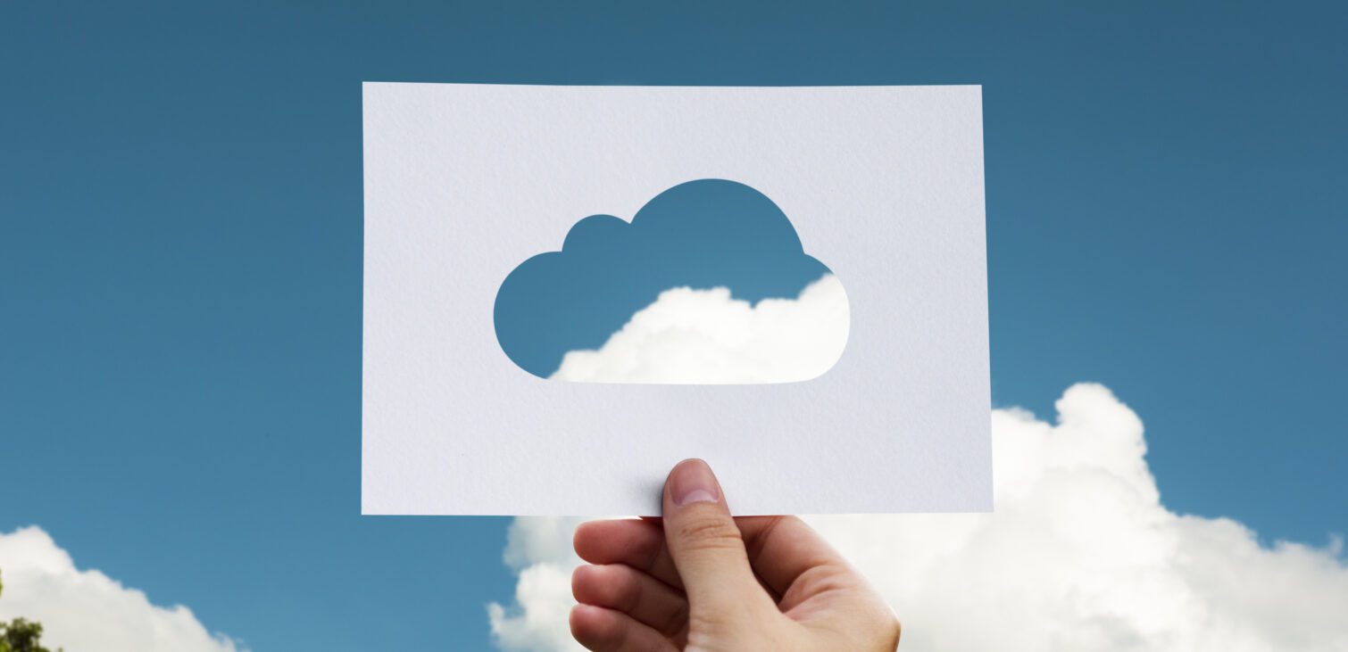 cut our cloud image on paper in a nature concept with skyscape and trees.
