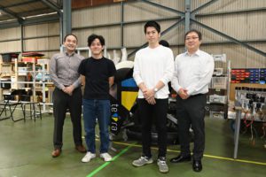 Four engineers with a flying car