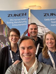 Dana standing next to her colleagues in front of the Zuken booth at WHMA 2022.