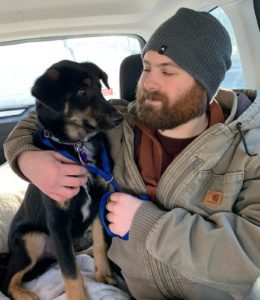 A man embracing his dog.