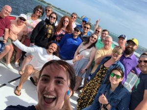 A small group of people, smiling for the camera on a boat in the Gulf of Mexico
