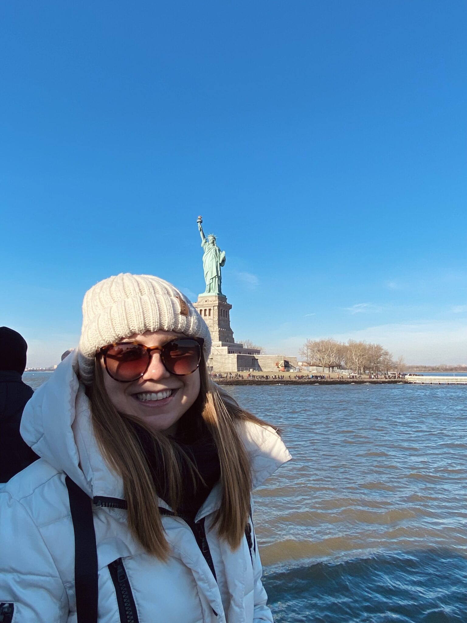 Girl in front of Statue of Liberty