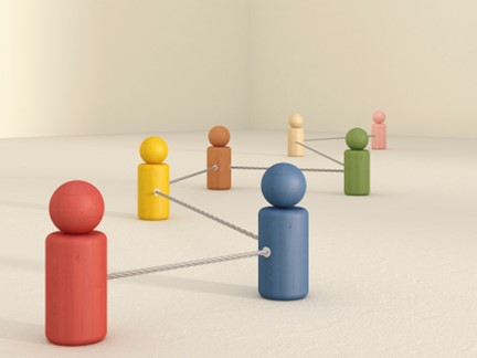 Colored wooden block figures connected with string