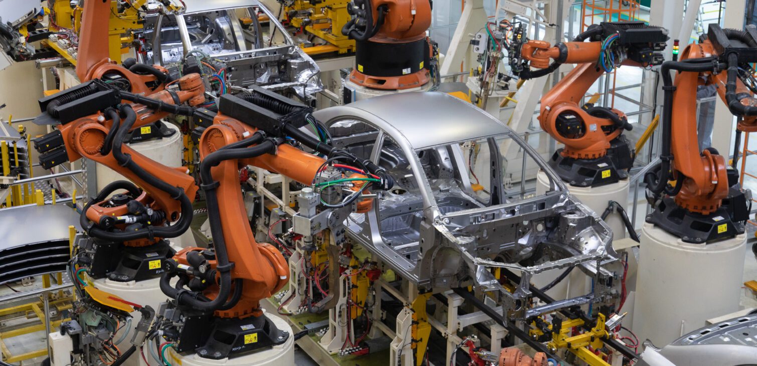 Car bodies on an assembly line. A factory for the production of cars. Modern automotive industry. Electric car factory, conveyor.