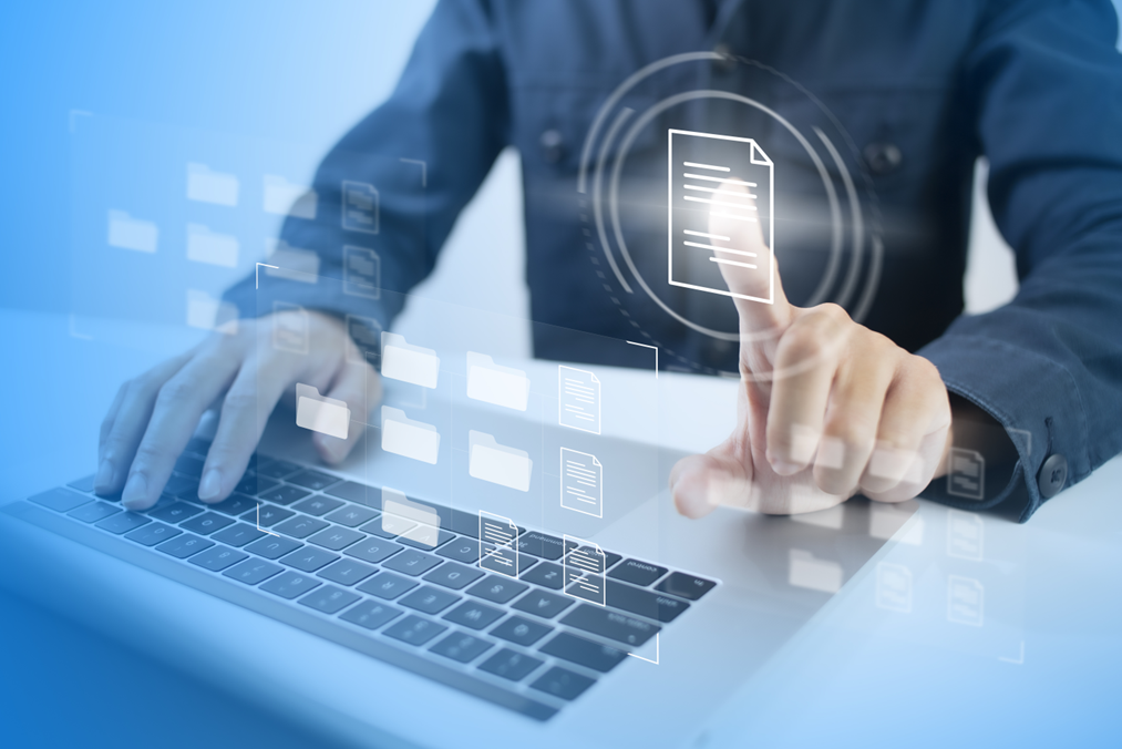 Engineer using a laptop and virtual interface with floating document icons