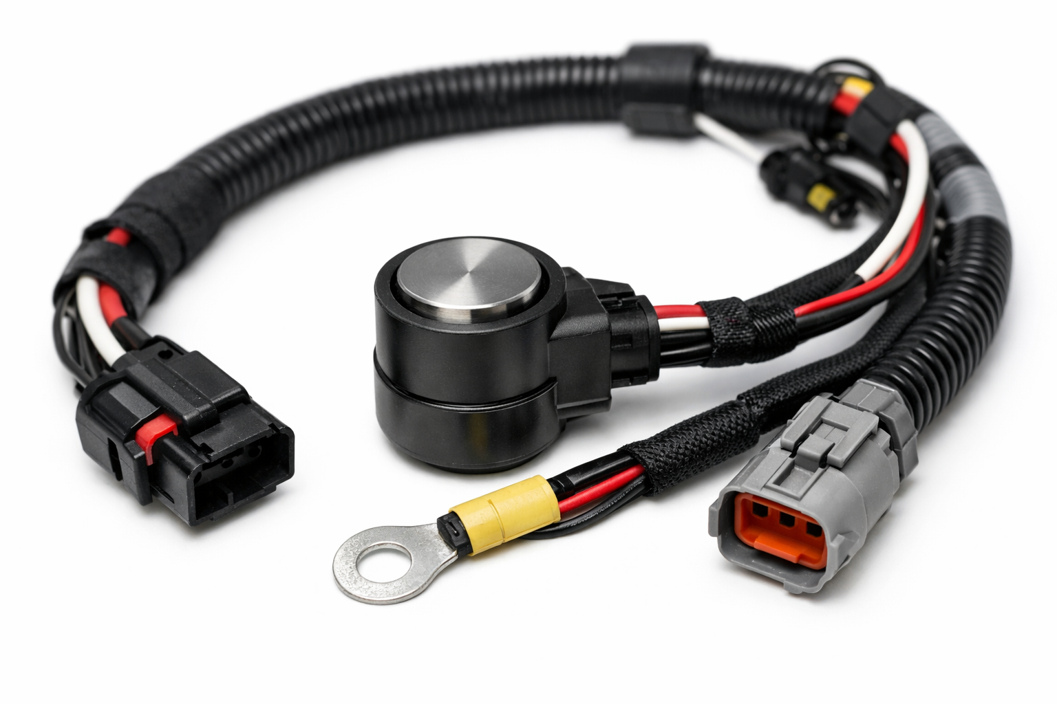 Close-up of wire harness with cylindrical sensor on white background