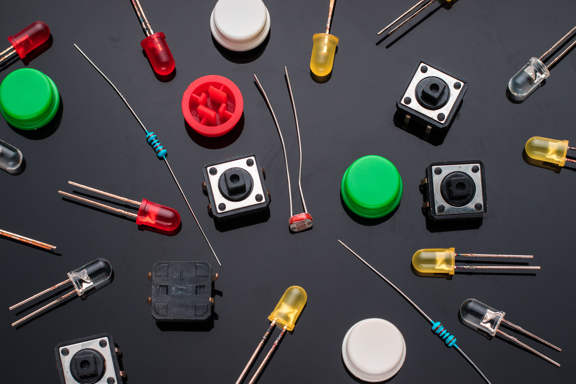 Assorted switches, LEDs, and components representing non-connector electrical devices