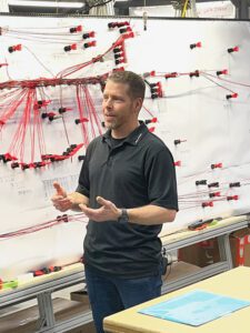 François Martel discussing wire harness production improvements.