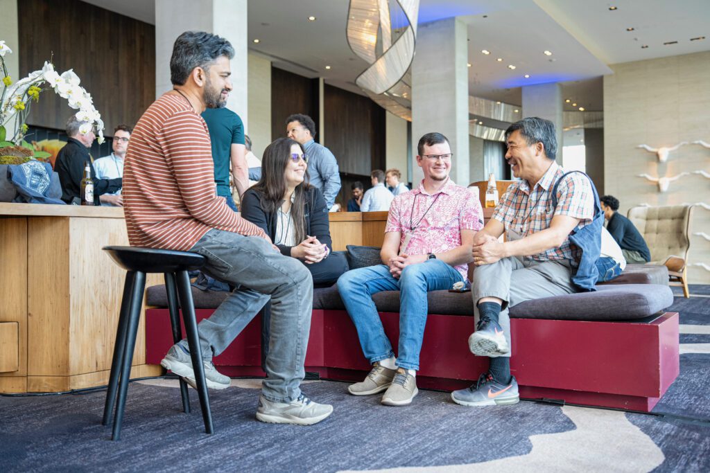 ZIW 2026 attendees talking in a lounge area between conference sessions.
