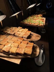 Short rib grilled cheese bites served on wooden trays during ZIW 2026.